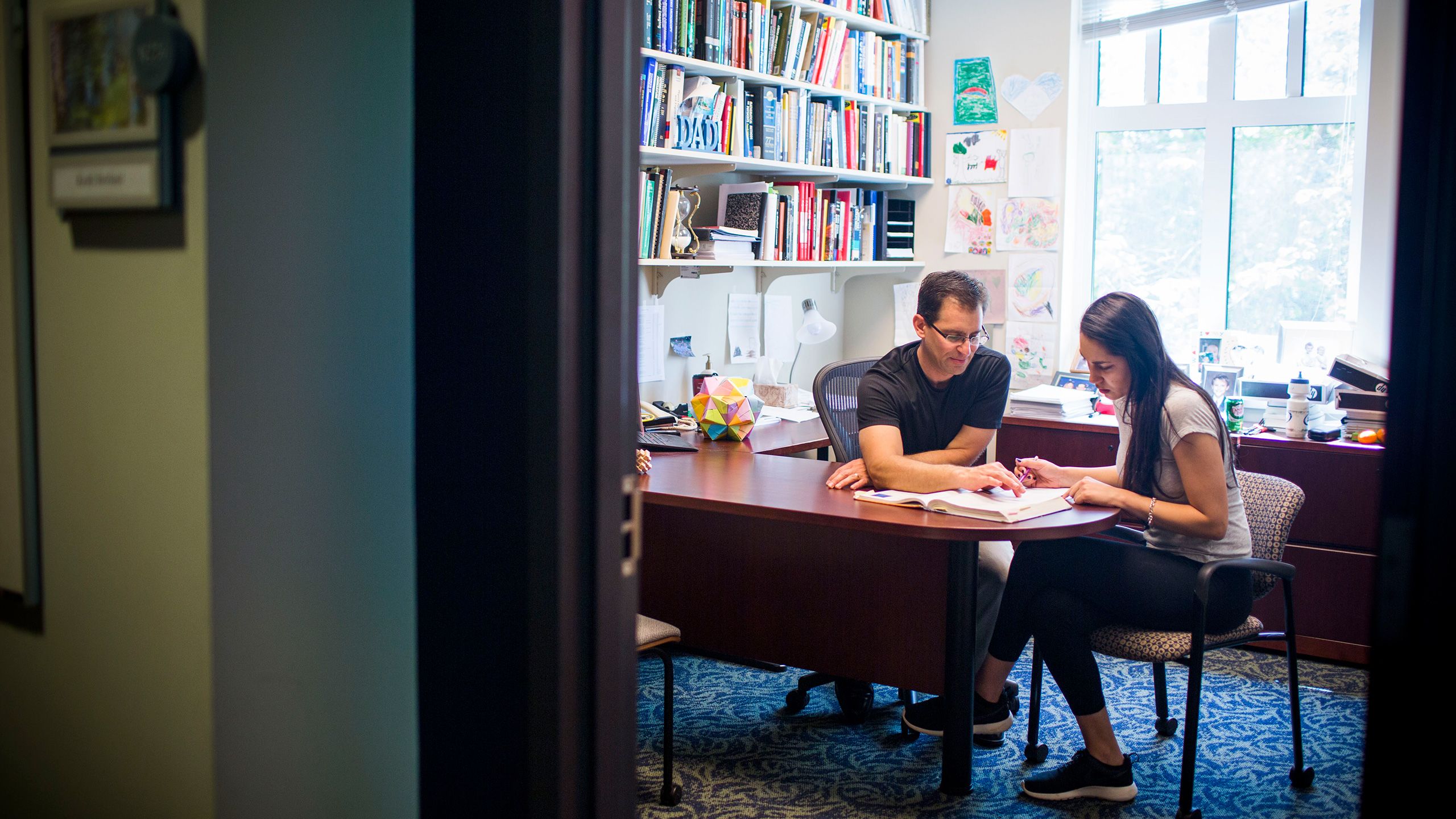 Physics Professor Dr. Keith Berland with Emory College student Stephanie Wahab in his office.