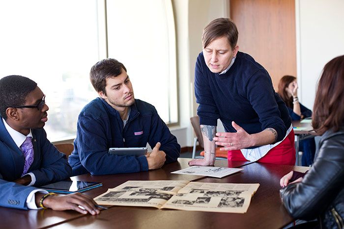 faculty and students discussing archival material in Rose Library