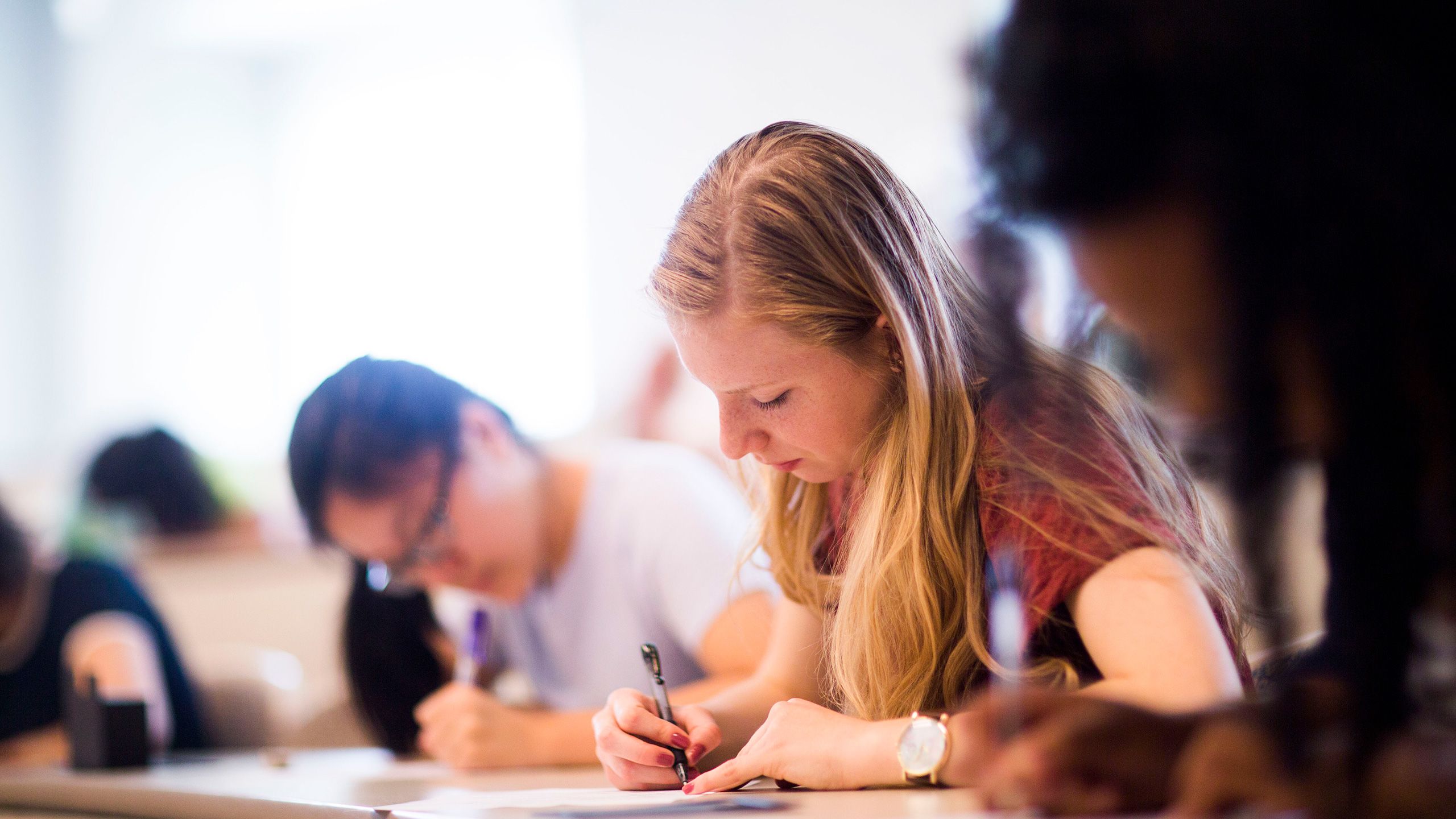 female student writing in class