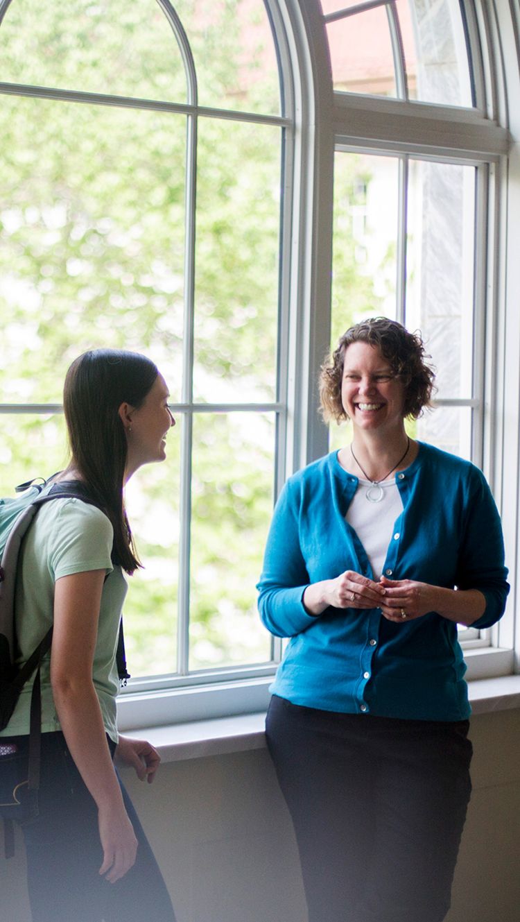 Director of Undergraduate Studies and Lecturer at Emory College, Amanda Freeman with Emory college student Kaitlyn Oelkers in front of window in Candler Library